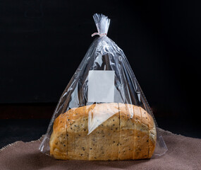 Black sesame bread freshly baked homemade is placed on a wooden cutting board and cut into equal strips. Good to eat for health.