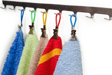 Colored terry towels hanging on the hanger hooks