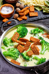 cream soup with broccoli and croutons in a pot