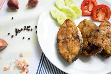 Delicious fresh king fish fried on a white plate
