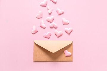 Pink love hearts from envelope on pink background. Valentine's day greeting card with copy space.