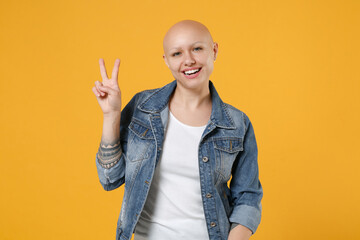 Young bald smiling caucasian friendly woman 20s without hair wearing casual denim jacket white...