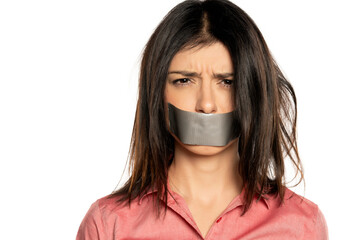 Woman with tape over mouth, isolated on white. 