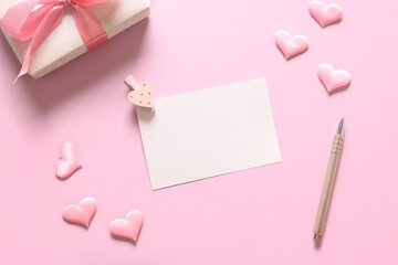 Empty blank for Valentine card with gift and pink romantic hearts on pink background. Greeting card with copy space.