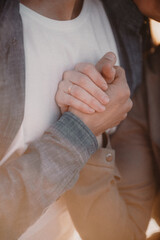 close up of a person holding a hand of a person