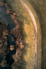 Aerial view of winding road and swampy river oxbow landscape, top view from drone pov