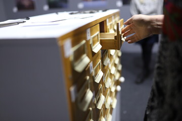 person holding a drawer in the library
