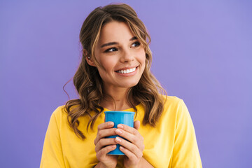 Happy beautiful nice girl smiling while drinking coffee