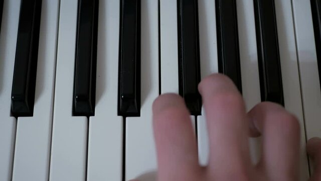 Close-up of the hands of a professional musician who plays the synthesizer during a concert.