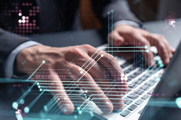 Hands typing the keyboard to create innovative software to change the world and provide a completely new service. Close up shot. Hologram tech graphs. Concept of Dev team. Formal wear.