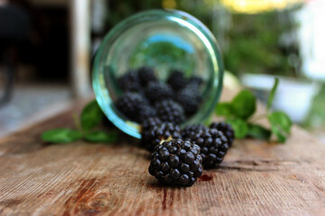 Photo with blackberries spilling out of the jar.