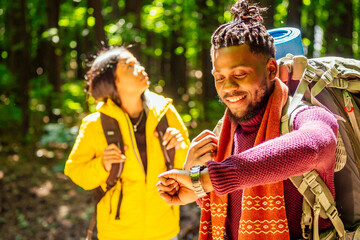 afro american mixed race couple establishing installation a tent and having a rest time outdoors