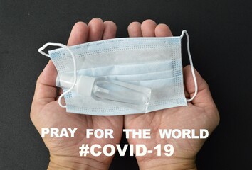 Man hand pray with face mask and hand sanitizer. Concept of Covid-19 outbreak.