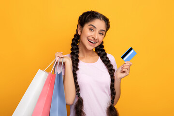 Indian woman holding plastic credit card and shopping bags