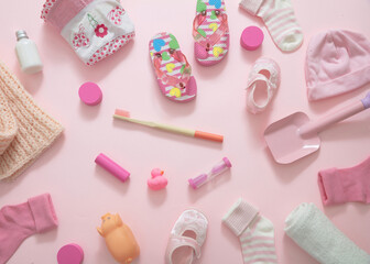 Baby girl accesories on pink background, baby shower concept