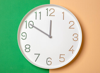wall clock on a colored background show ten o'clock