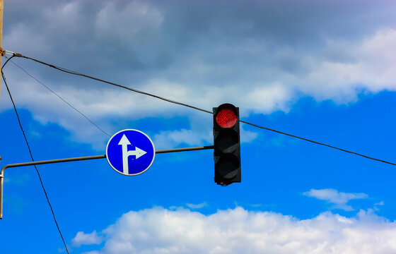 Red traffic light signal againstblue sky, a pointer for the motorist on the road