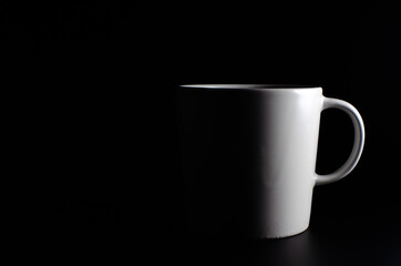 Coffee mug cup with light and shadow modern style on single position and presentation black background, empty tea cup isolated wallpaper.