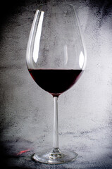 Bordeaux Wine glass with red wine on white smoke background. light reflection. 