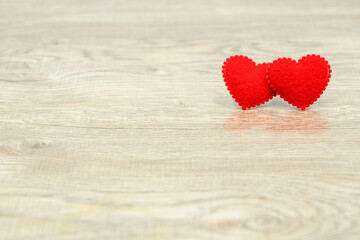 Two red love heart on wood texture background