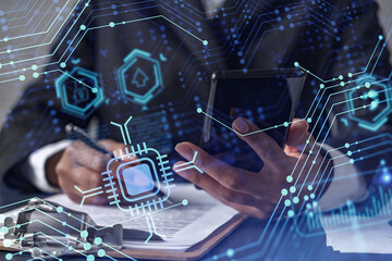 African American businesswoman is signing the contract to create a start up for the conference and gain investments for innovative service. Checking the details at smartphone. Hologram tech graphs.