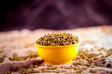 Raw Organic moong bean heap in white Bowl with selective focus on Mung dal (Vigna radiata) aka green gram,Broken Mung Lentils
