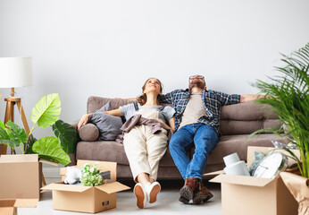 Tired couple relaxing on sofa during relocation