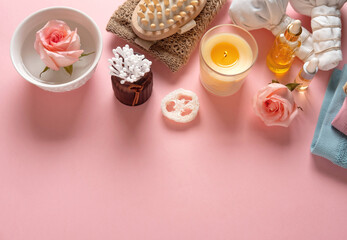 Natural skincare cosmetic products on pink pastel background. Soap, oils, sea salt. Organic cosmetics, spa concept. Empty space, flat lay, top view.
