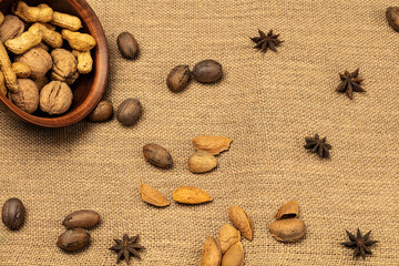 Walnut almonds peanuts in a wooden bowl over wooden background