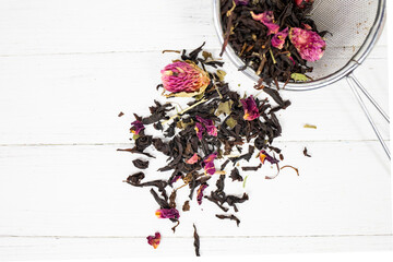 Natural herbal tea scattered on a white background.