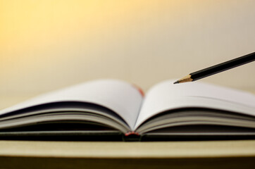 Lovely open book pages, study notes, love letter diary for hobbies concepts. Warm and welcoming color tone. Set up up wood table clear white background