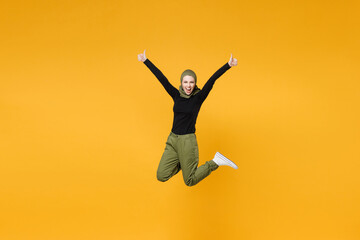 Full length crazy young arabian muslim woman wearing hijab black green clothes jumping rising hands...