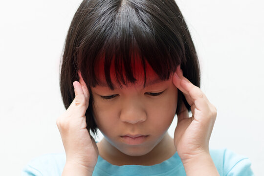 Child headache concept. Asia female kid hand on her head with red spot as brain illness