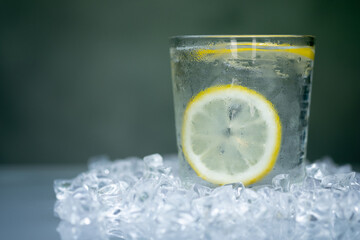 A glass of cool water with slice lemon inside