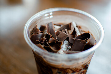 Chocolate drink with shredded chocolate on top, close up and blurred background 
