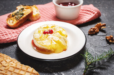 Delicious beautiful baked camembert with honey, walnuts, herbs and cranberries.