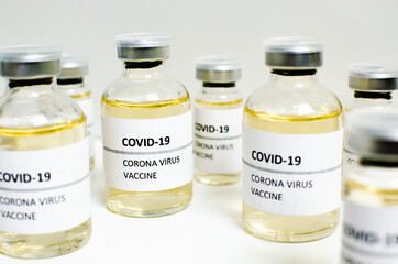 Covid-19 or Coronavirus vaccine in mini medicine bottles on white background, concern disease pharmacy in laboratory and drug to cure people. Healthcare and Medical concept. Development of research.