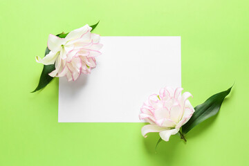 Beautiful lilies and blank card on color background