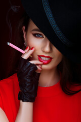 Obraz premium Beauty Portrait Fashion Editorial Red Lips Pink Cigarette Smoke Black Hat Leather Gloves