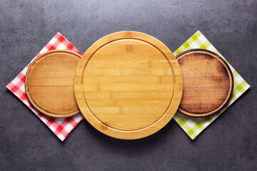 Pizza or bread cutting board and cloth napkin for homemade baking on table. Food recipe concept at stone background