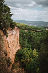 Fototapeta premium Rock face in the Ochre Path le Sentier Les Ocres through the Red Cliffs of Roussillon Les Ocres, a nature park in Vaucluse, Provence, France. Looks like Bryce NP.