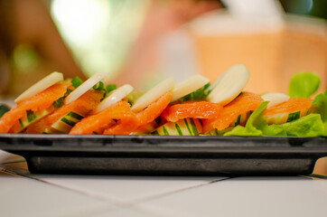 Salmon spicy salad blurred background