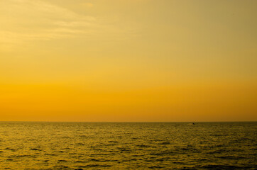 Sunset time with ocean view warm color tone and sun reflection on the sea for wallpaper and background