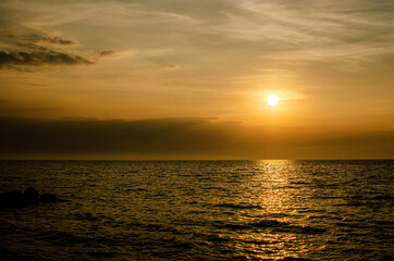 Sunset time with ocean view warm color tone and sun reflection on the sea for wallpaper and background