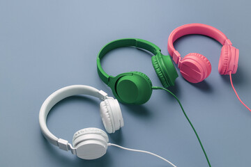 Set of three retro headphones over blue background. Music concept.