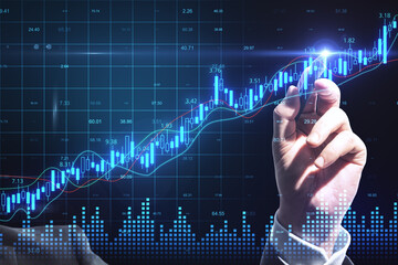 Businessman hand drawing glowing stock charts with big data interface