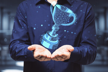 Businessman hand holding digital polygonal winner cup