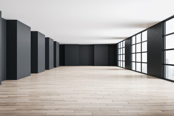 Gallery interior with large window and wooden floor.