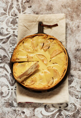Homemade apple tart pie on wooden board, top view