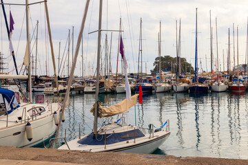 Fototapeta premium White yachts in the sea harbor of Kemer, Antalya province in Turkey. Kemer Marina on the Mediterranean sea